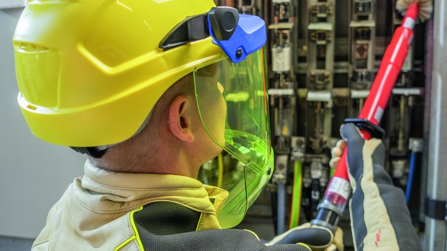Cleaning a low-voltage switchgear using adequate personal protective equipment.