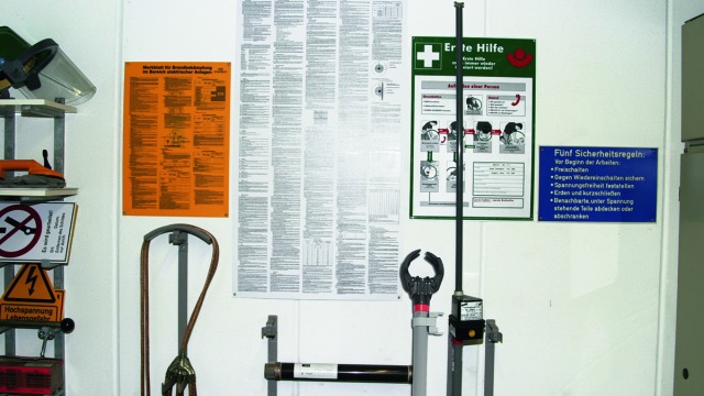 Warning and information signs displayed at an electrical installation